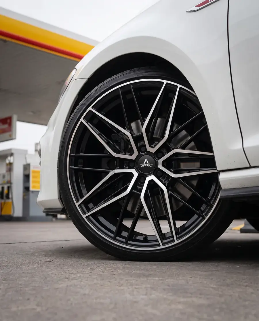 AXYS MOU en acabado Black Machined Face, montada en un Volkswagen Golf GTI blanco